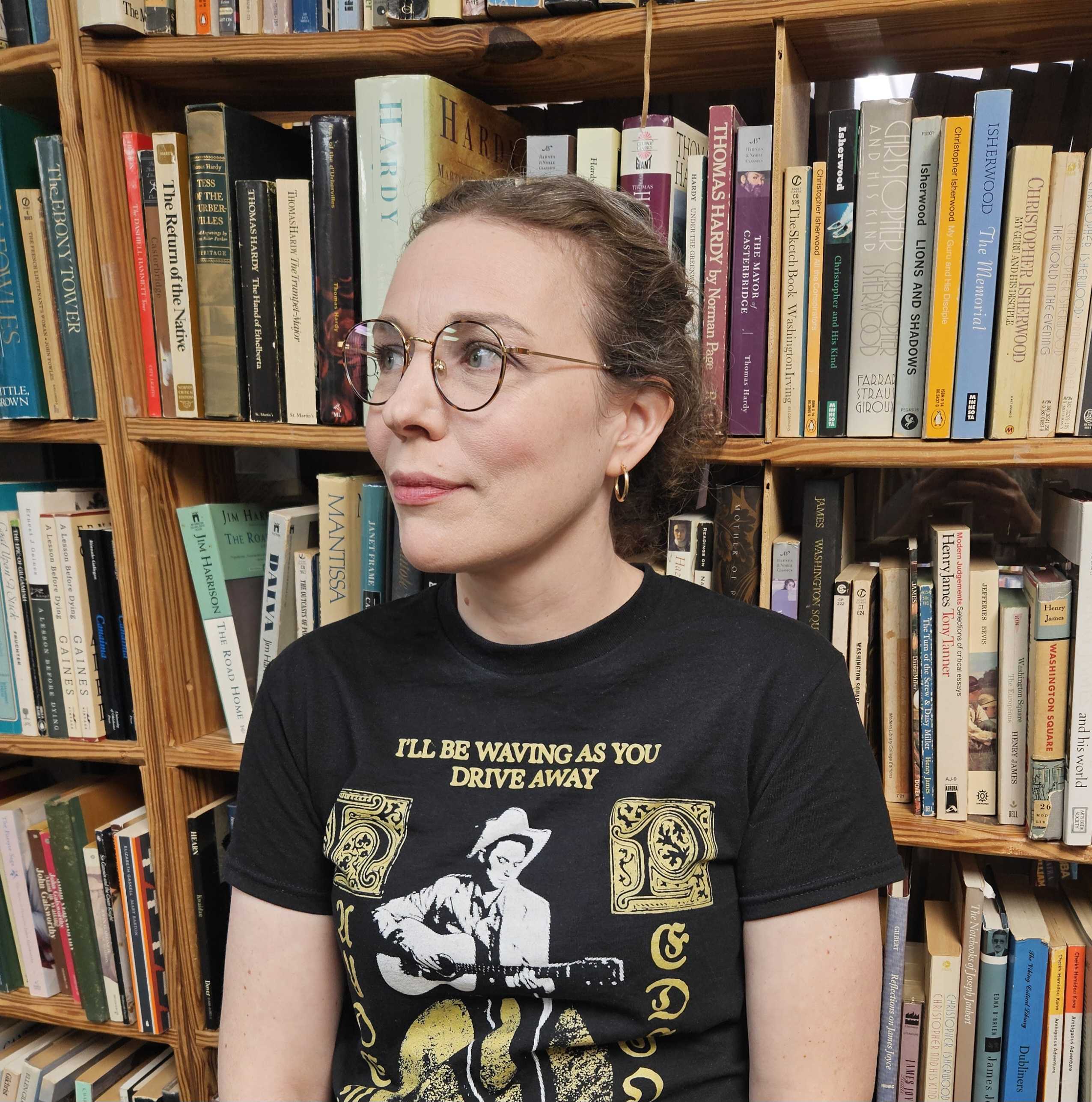 Headshot of Aleithia Stephens, a white woman with curly brown hair and round wire-rimmed glasses